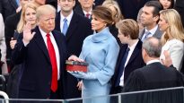 Donald Trump placing his hand on the Bible is sworn in as US President.