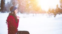 Woman praying in snow