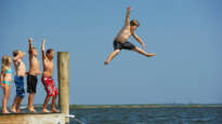 Kids jumping off jetty